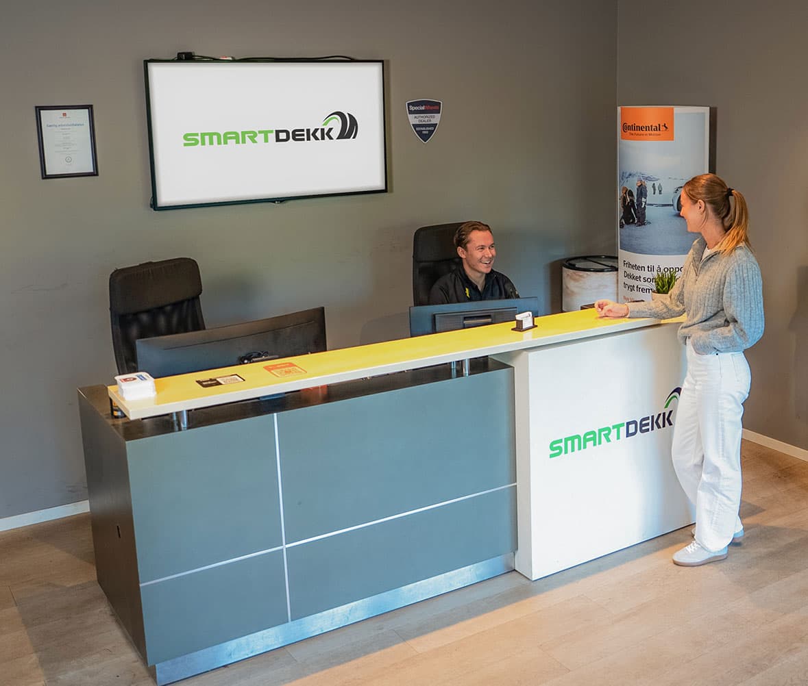 Modern Smartdekk tire shop reception area with customer service desk and product displays